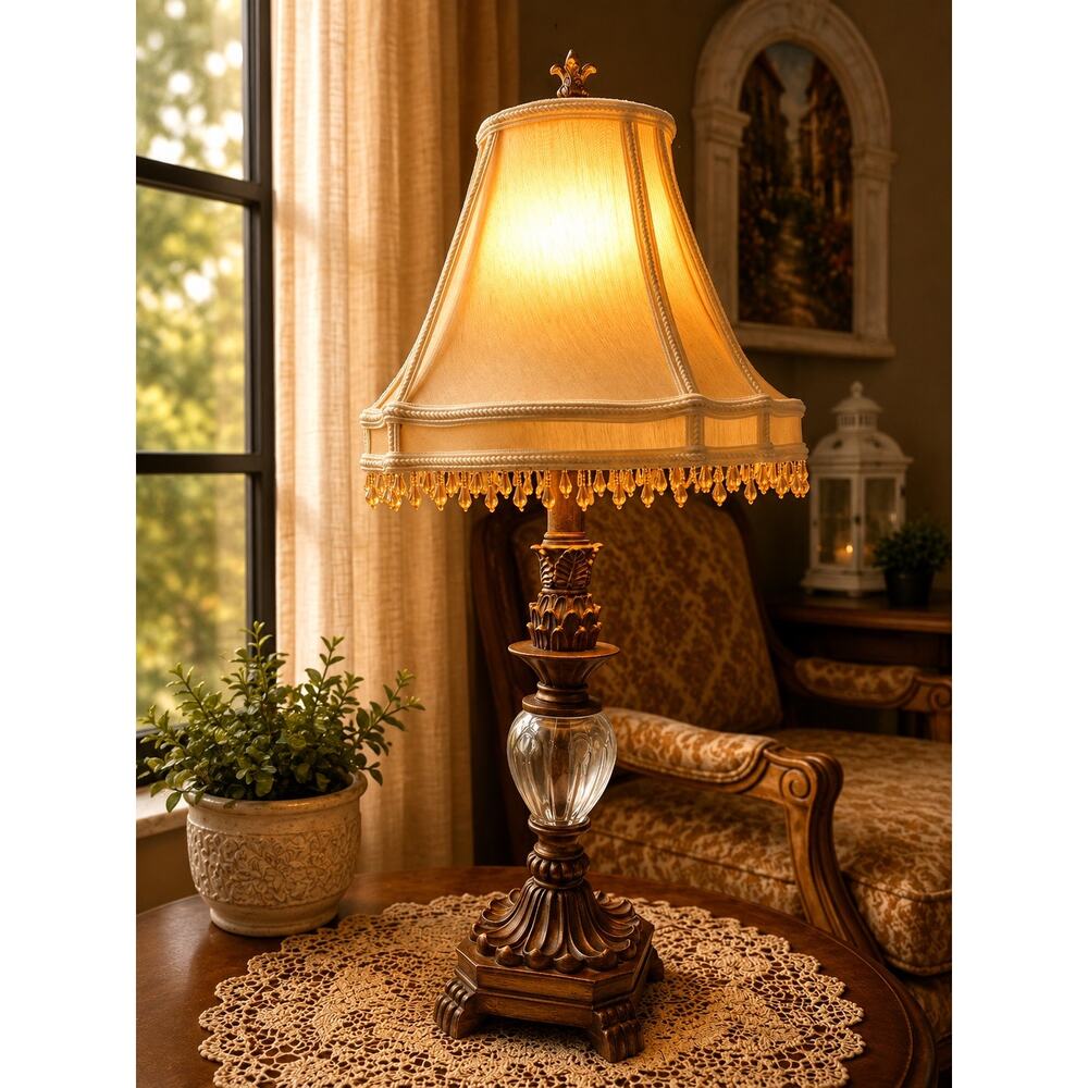 vintage-style table lamp featuring a brown, carved base and clear glass globe